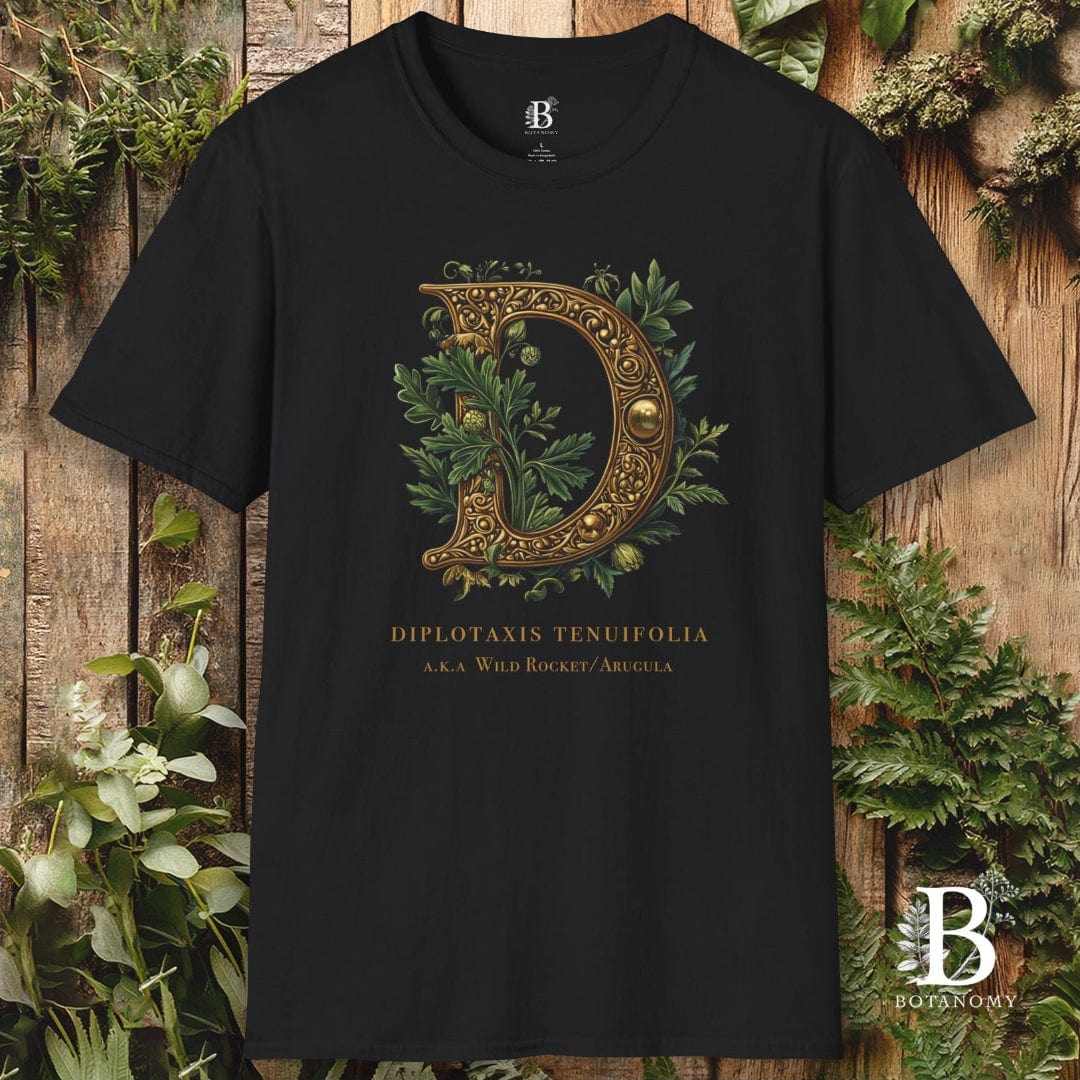 Black t-shirt with decorative letter 'D' design on a wooden background with plants