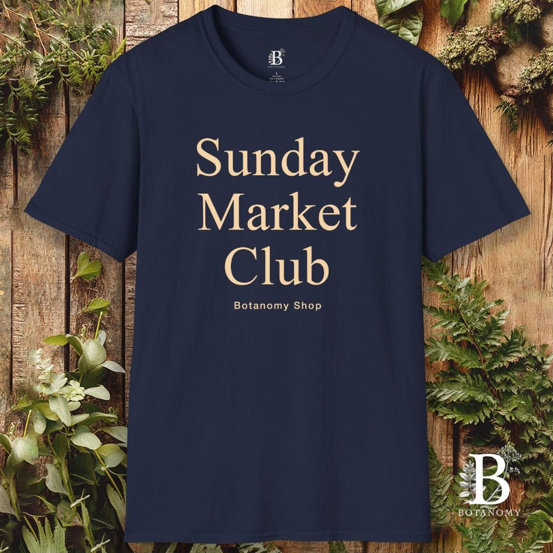 Navy blue t-shirt with 'Sunday Market Club' text on a wooden background