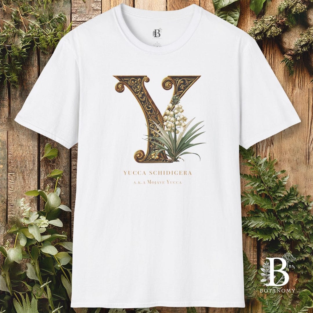 White t-shirt with decorative letter 'Y' design on a wooden background with plants