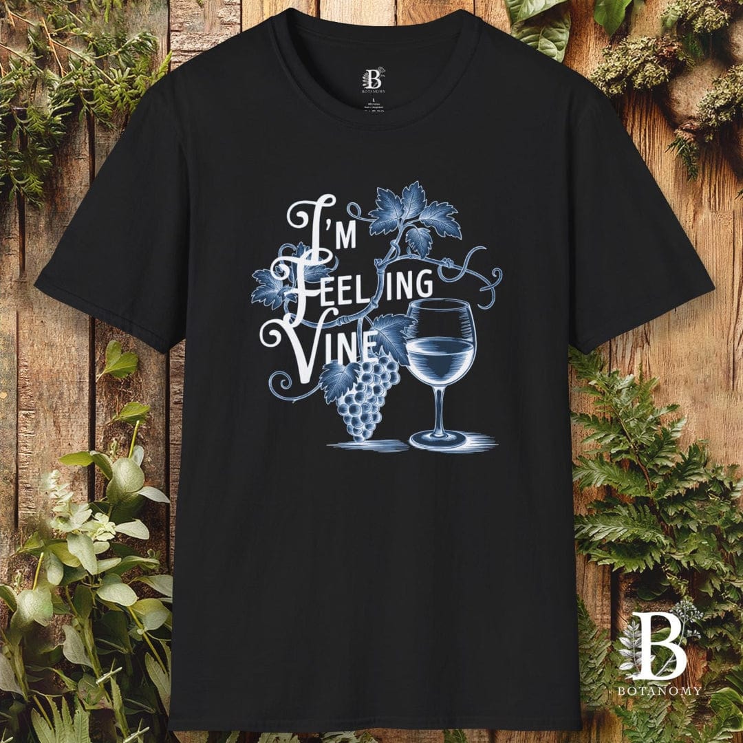Black t-shirt with a graphic design of a wine glass and grapes on a wooden background