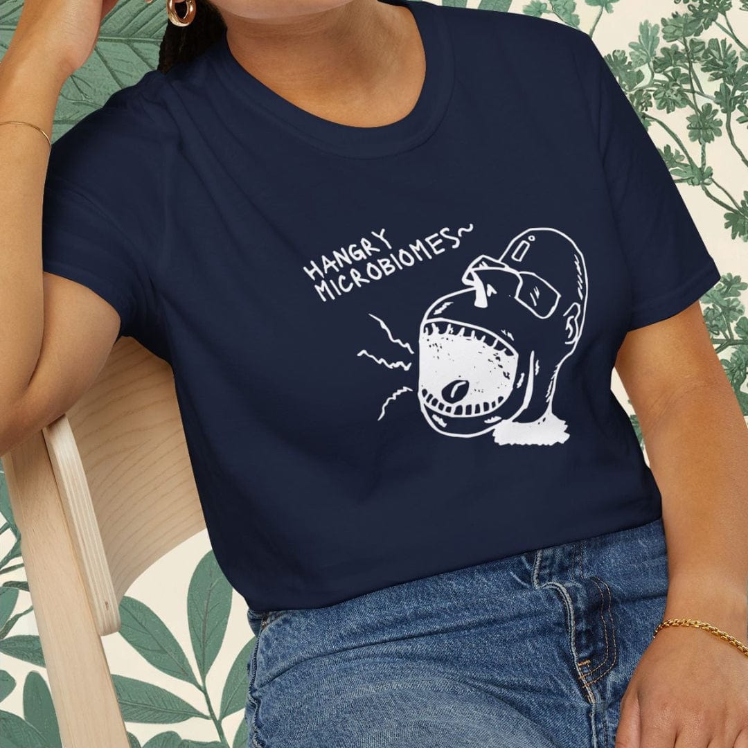 Person wearing a navy blue t-shirt with a graphic design sitting on a chair.