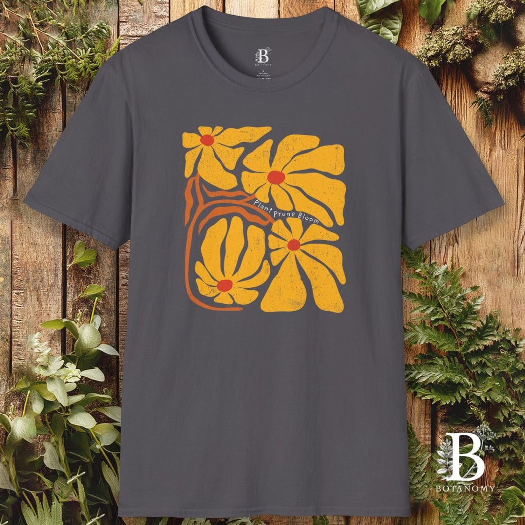 Gray t-shirt with yellow floral design on a wooden background