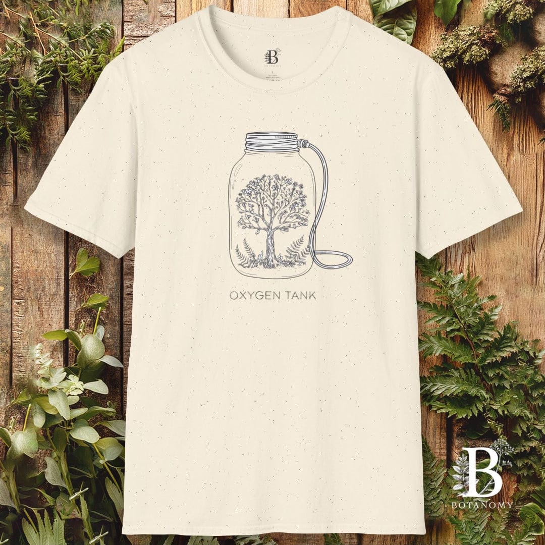 White t-shirt with an 'Oxygen Tank' graphic on a wooden background with plants