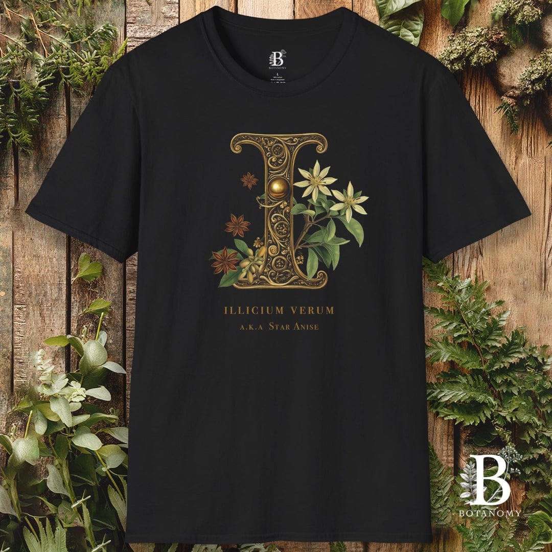 Black t-shirt with decorative letter 'E' design on a wooden background with plants