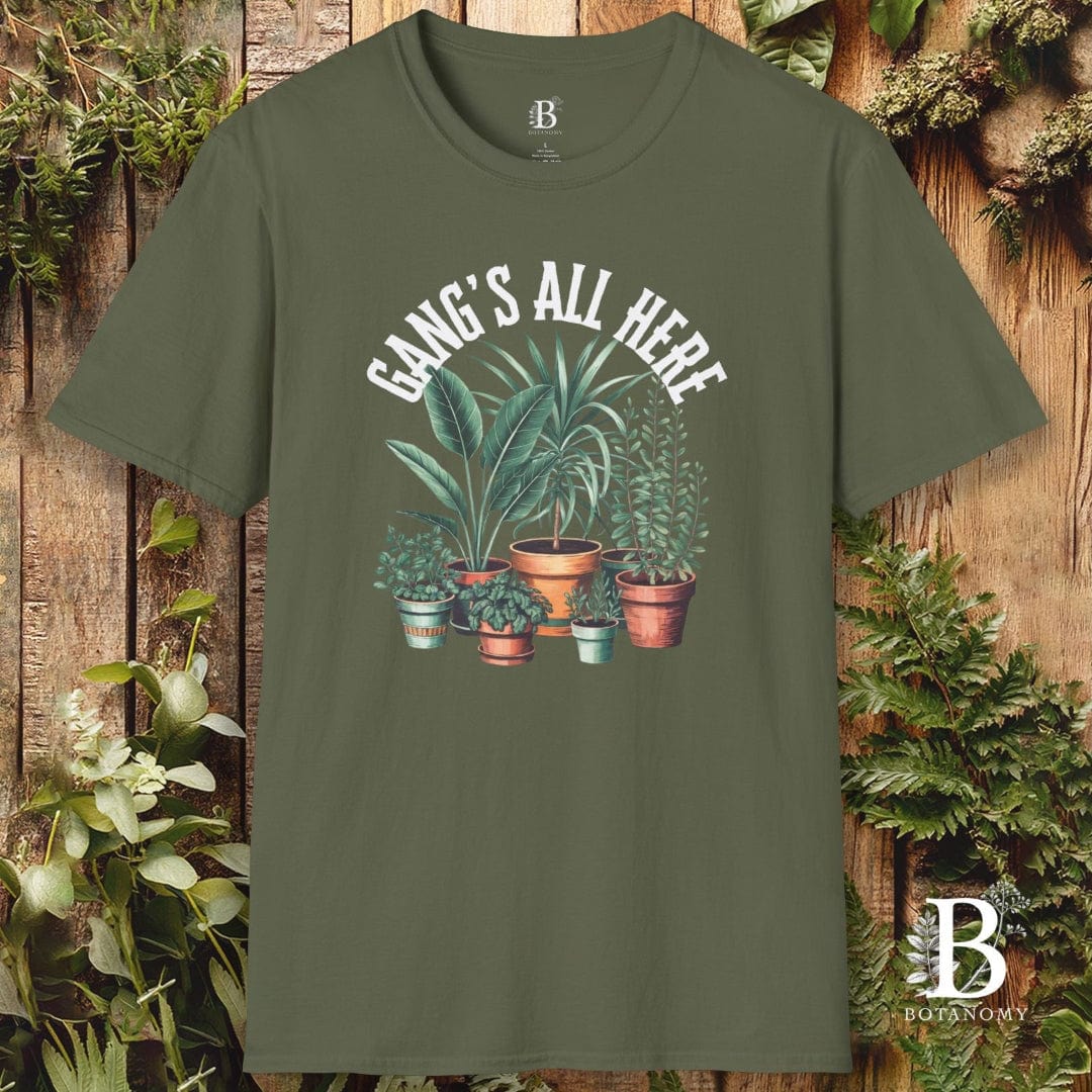 Green t-shirt with plant design and text 'Gangs All Here' on a wooden background
