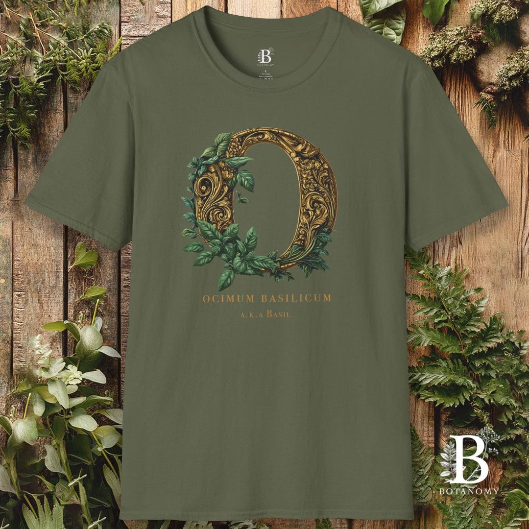 Green t-shirt with decorative letter 'Q' design on a wooden background with plants