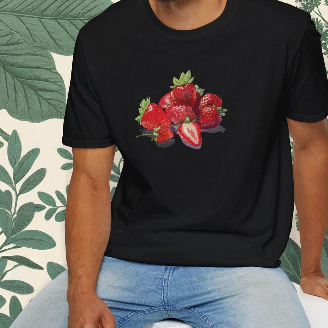 Man wearing a black t-shirt with strawberry design sitting on a white stool.