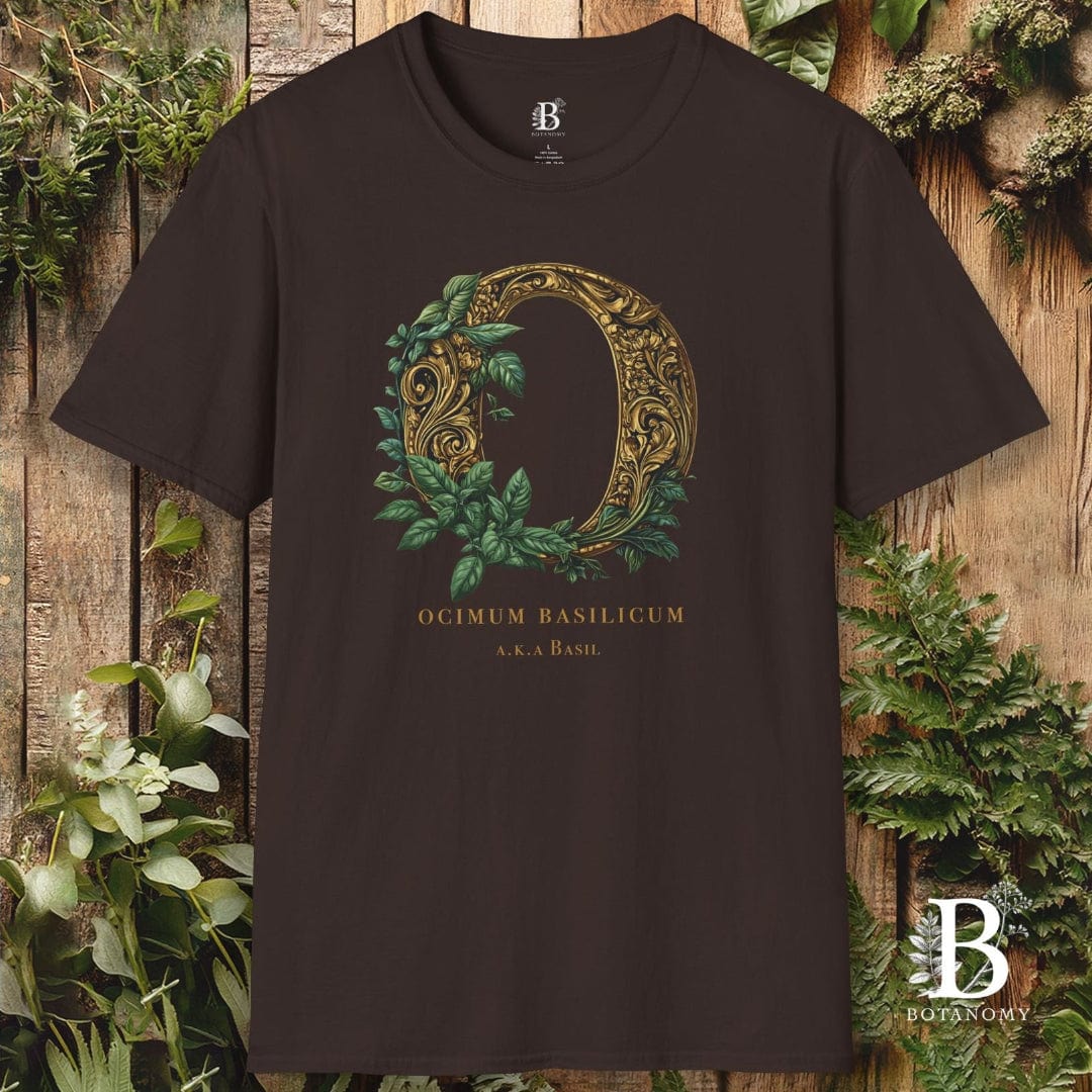 Black t-shirt with decorative letter 'Q' design on a wooden background with plants