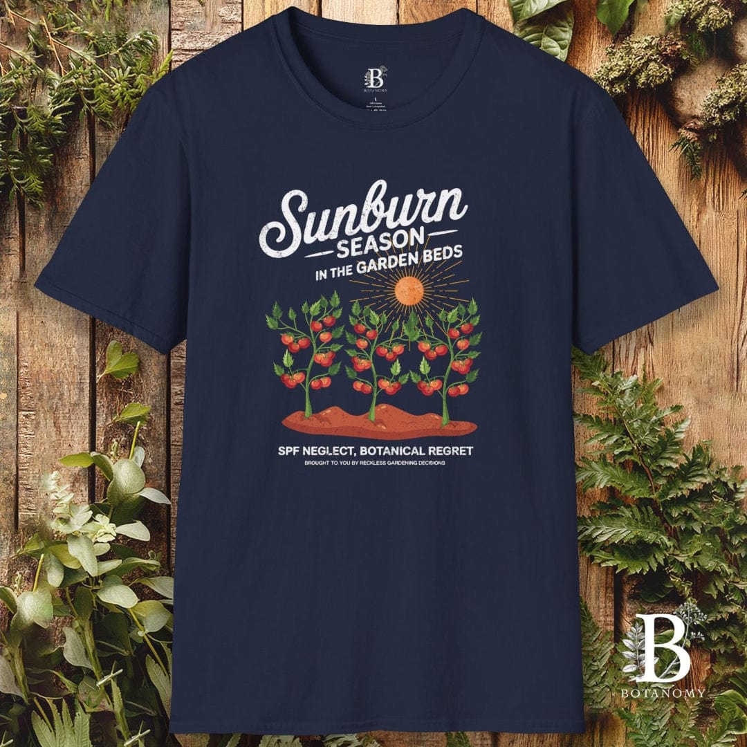 Navy blue t-shirt with garden-themed design on a wooden background