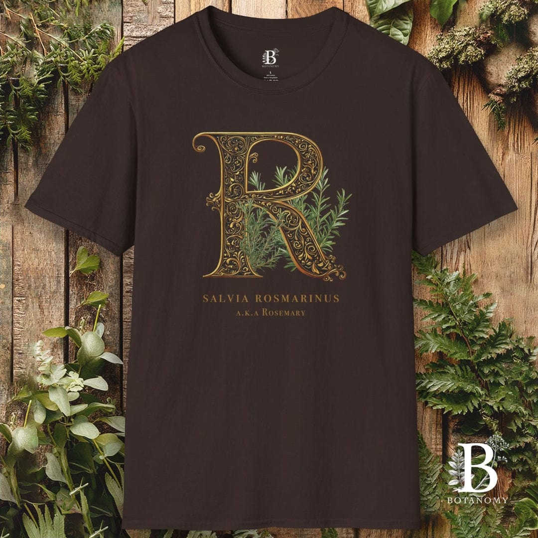 Brown t-shirt with decorative letter 'R' design on a wooden background with plants