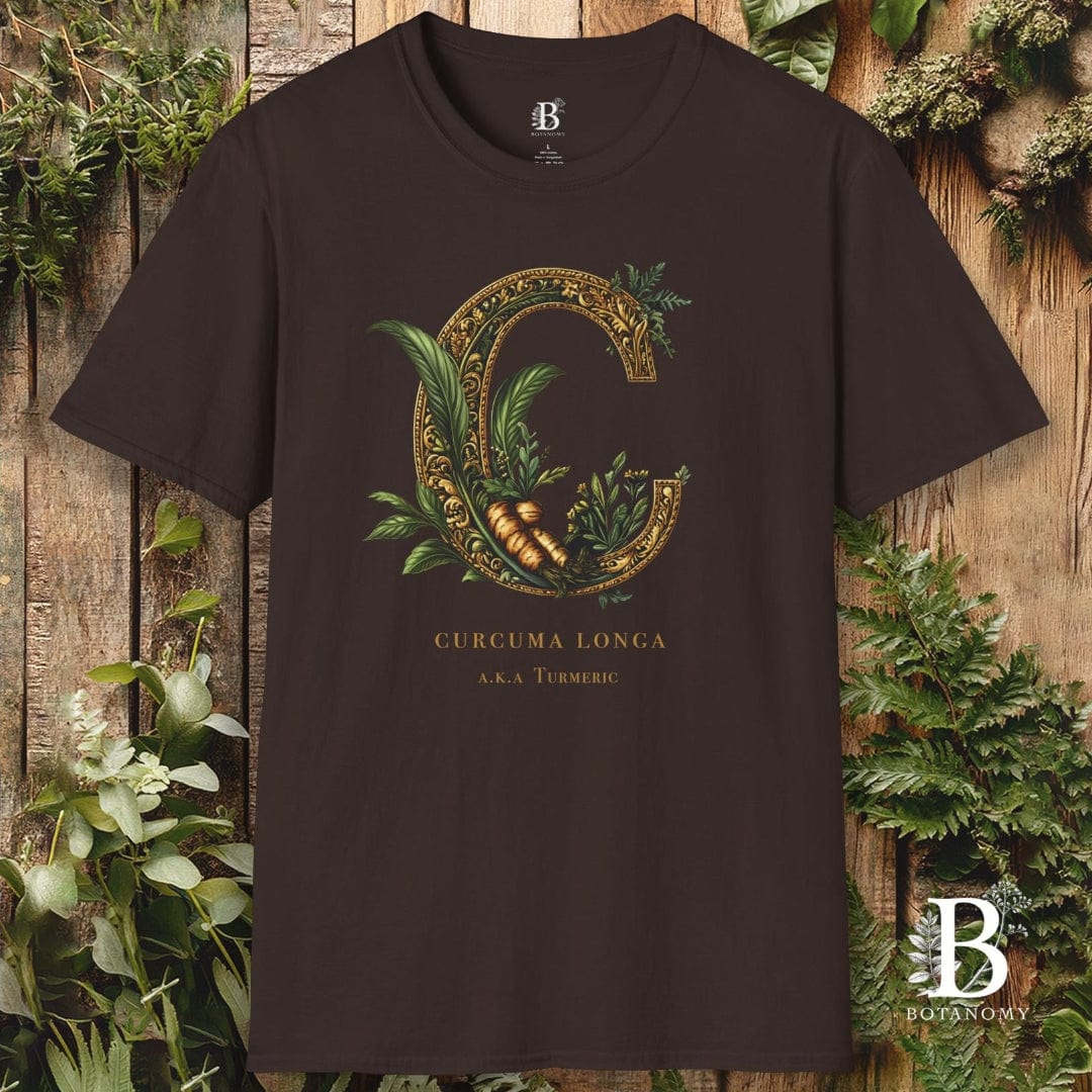 Black t-shirt with decorative 'C' design and brand logo on a wooden background