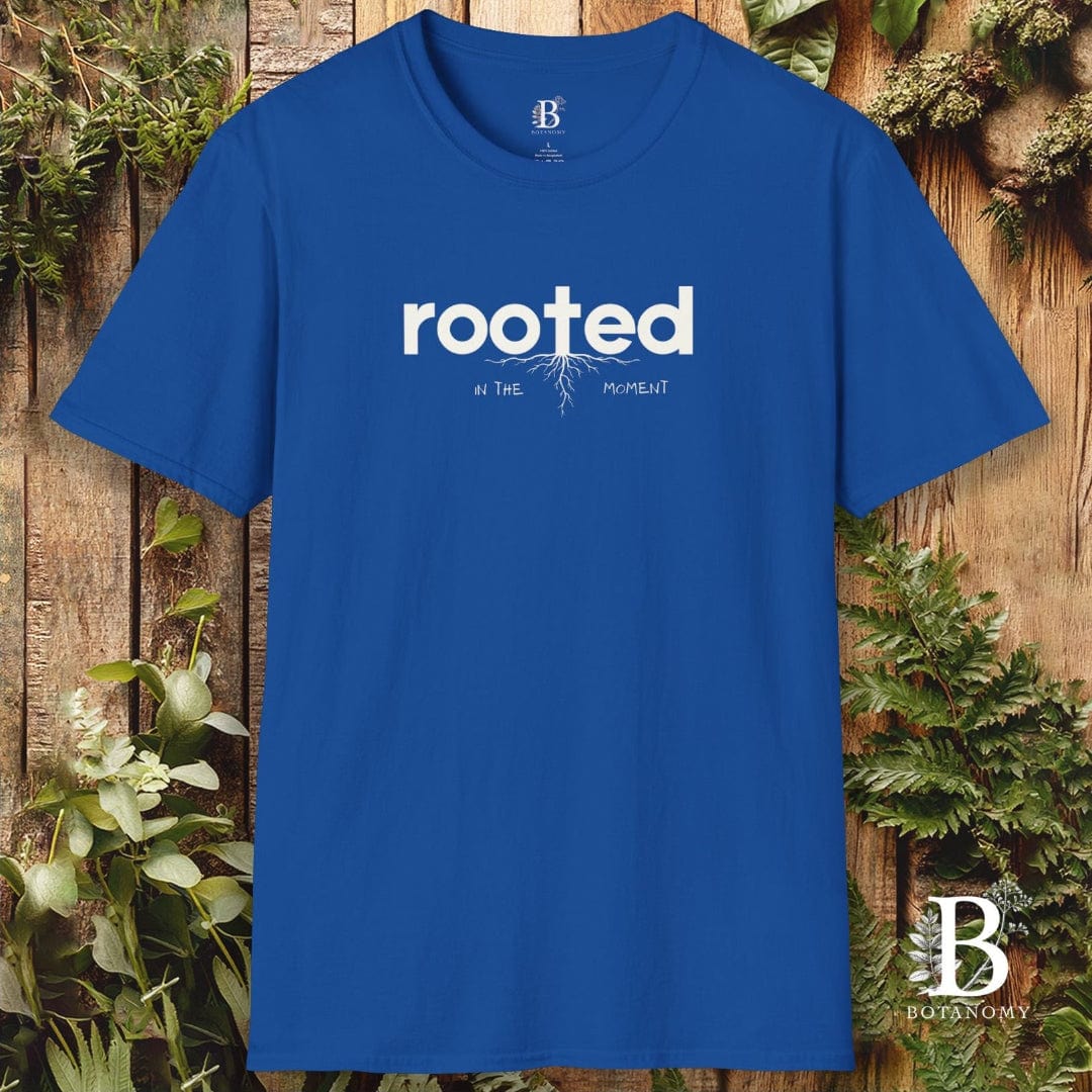 Blue t-shirt with 'rooted' text on a wooden background