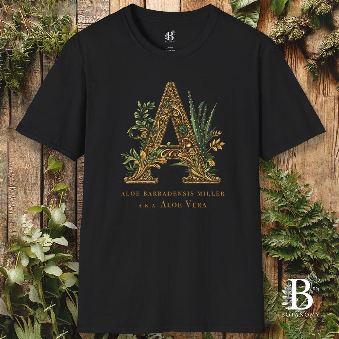 Black t-shirt with decorative letter 'A' design on a wooden background with plants