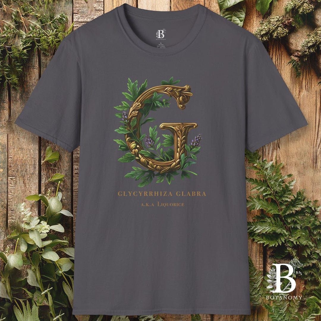 Gray t-shirt with decorative letter 'G' design on a wooden background
