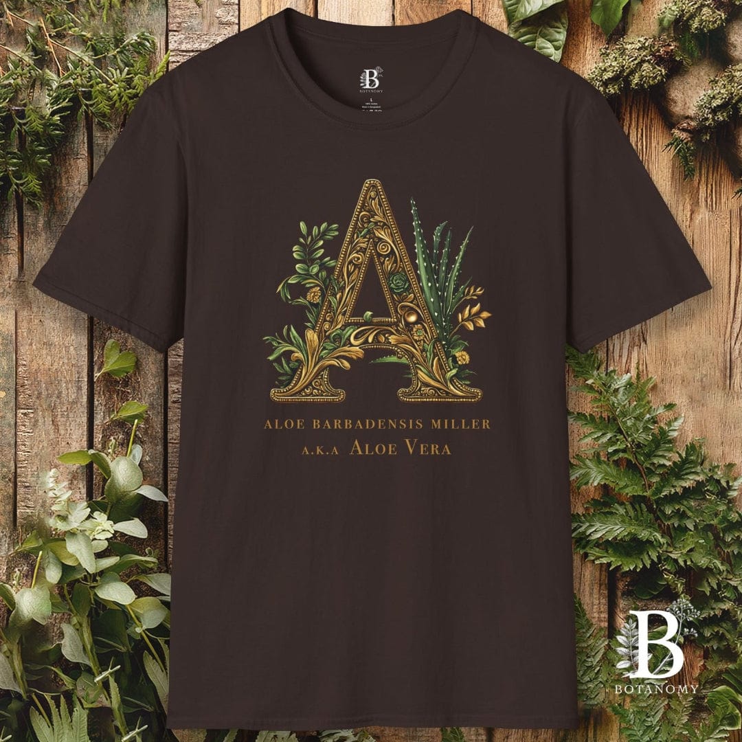 Brown t-shirt with decorative letter 'A' design on a wooden background