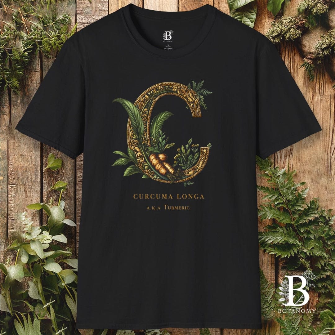 Black t-shirt with botanical design and brand logo on a wooden background