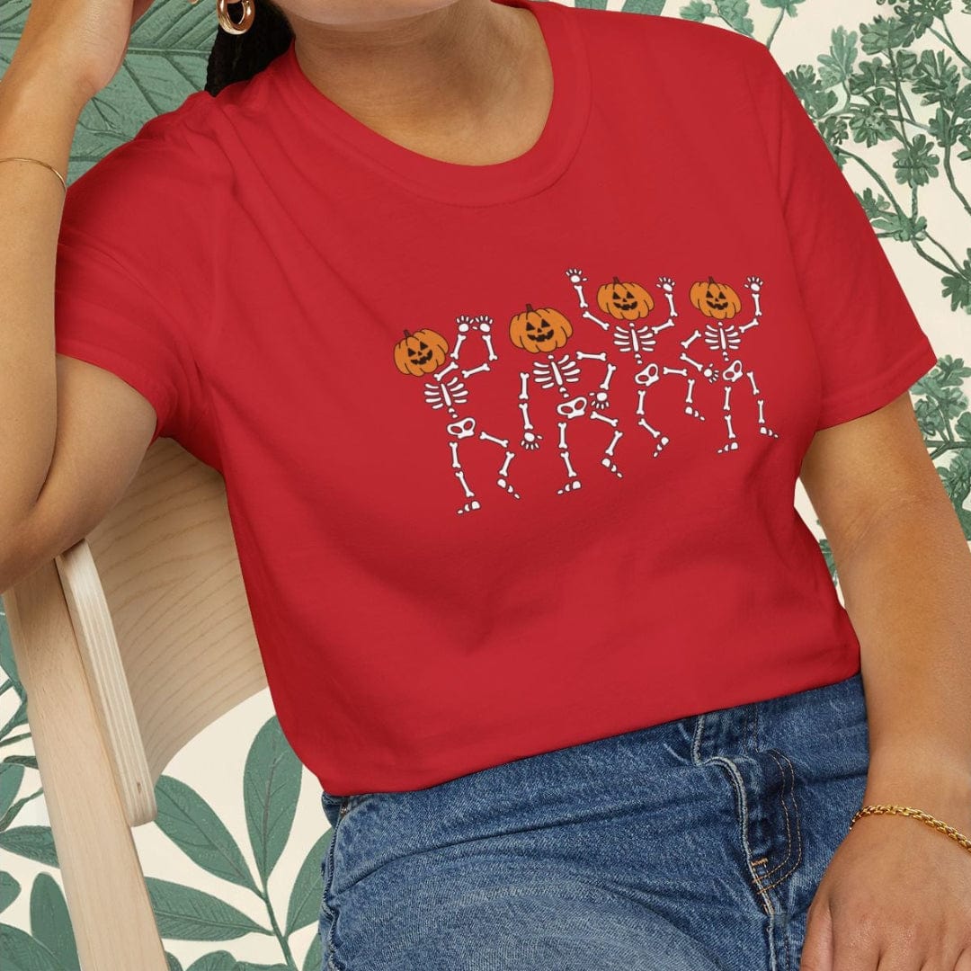 Person wearing a red t-shirt with Halloween-themed design sitting on a chair.