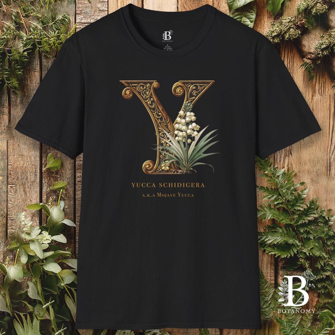 Black t-shirt with decorative letter 'Y' design on a wooden background with plants