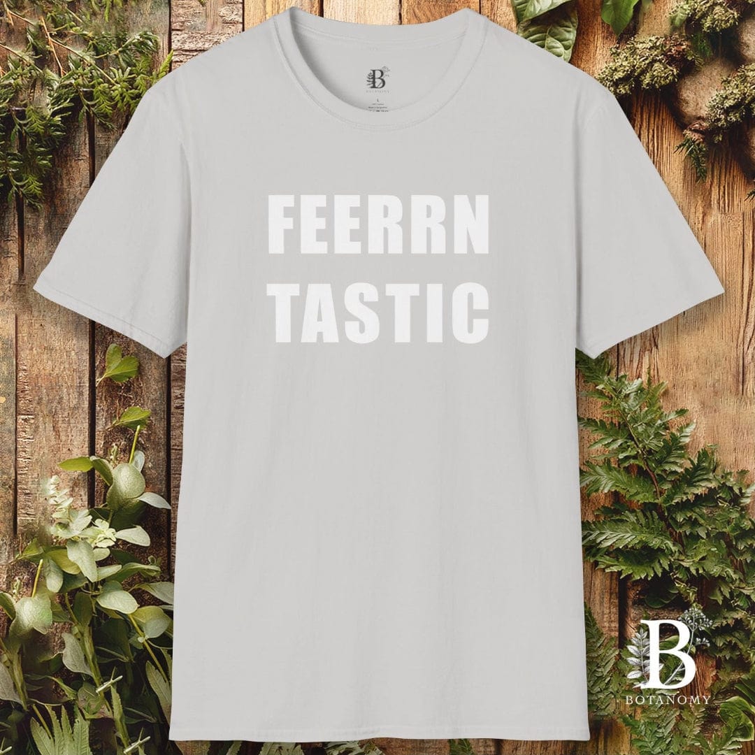 Gray t-shirt with 'FEERRN TASTIC' text on a wooden background with plants