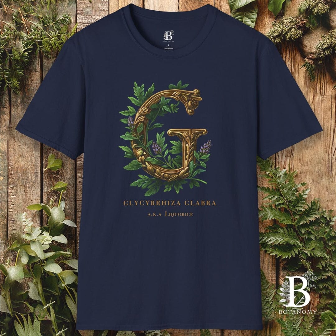 Navy blue t-shirt with gold letter 'G' and green leaves on a wooden background