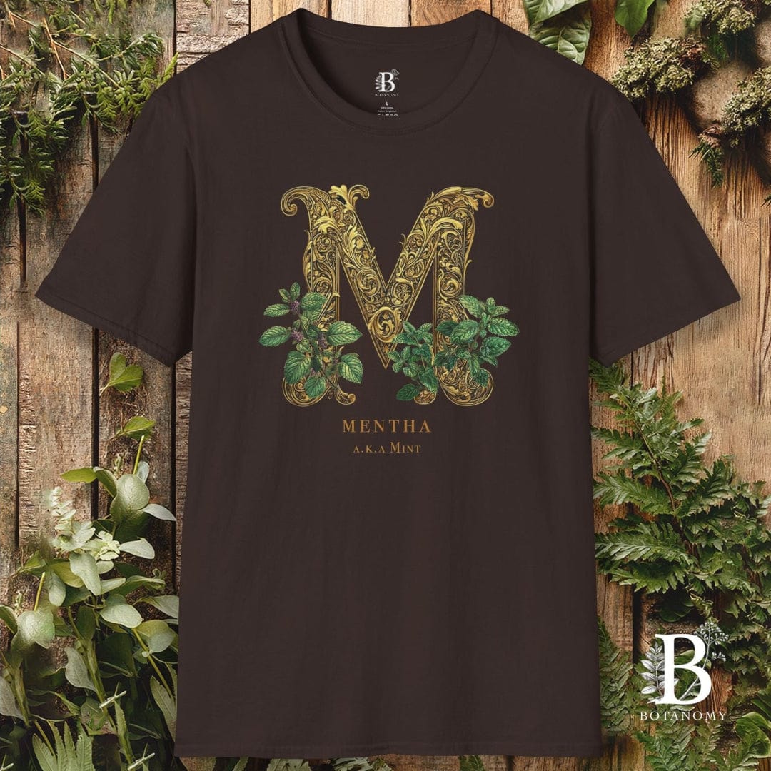 Black t-shirt with decorative 'M' design and 'Buteybo' branding on a wooden background with plants.
