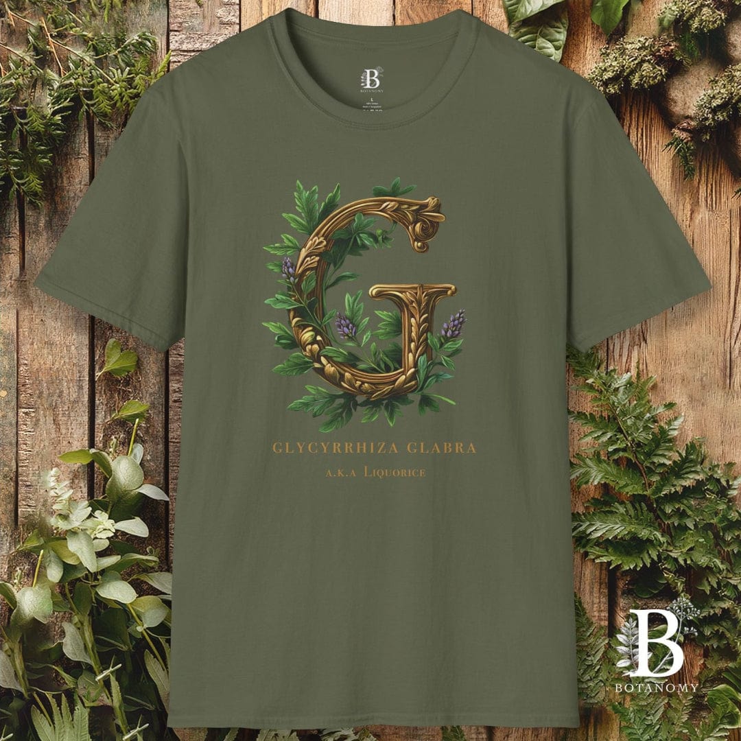 Green t-shirt with decorative letter 'G' design on a wooden background