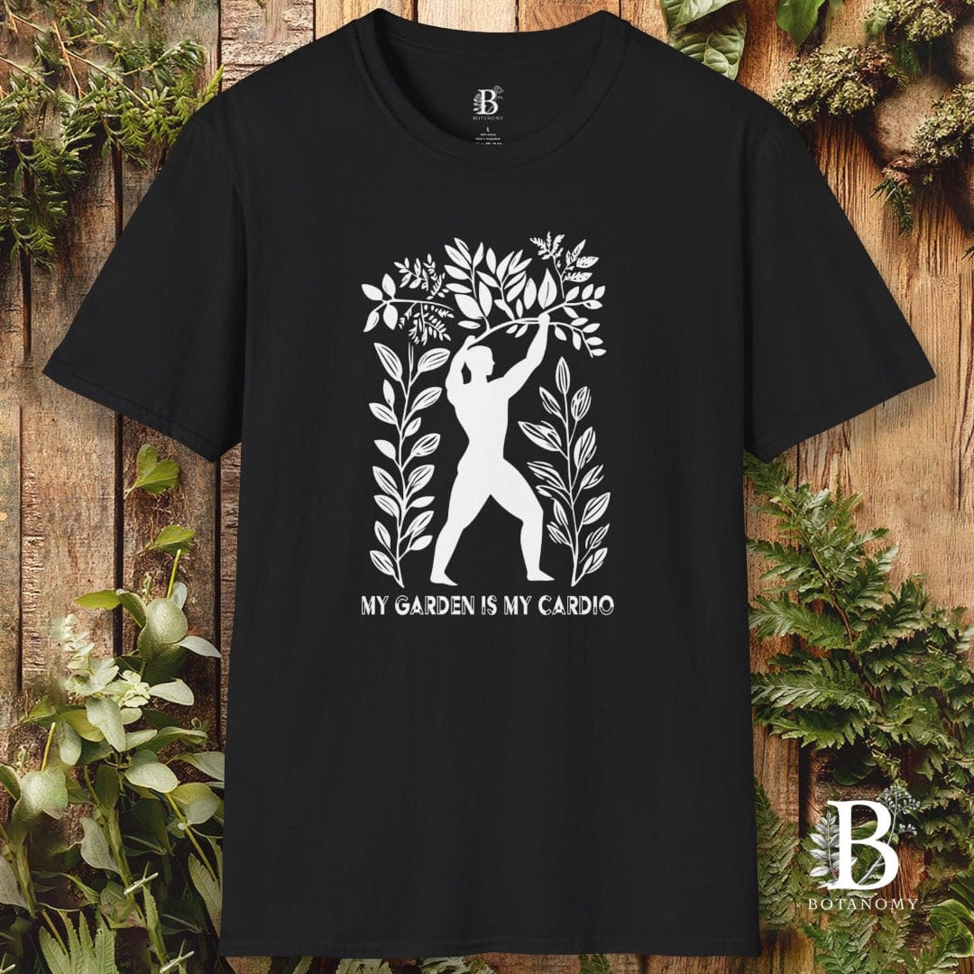 Black t-shirt with white graphic design and text on a wooden background with plants