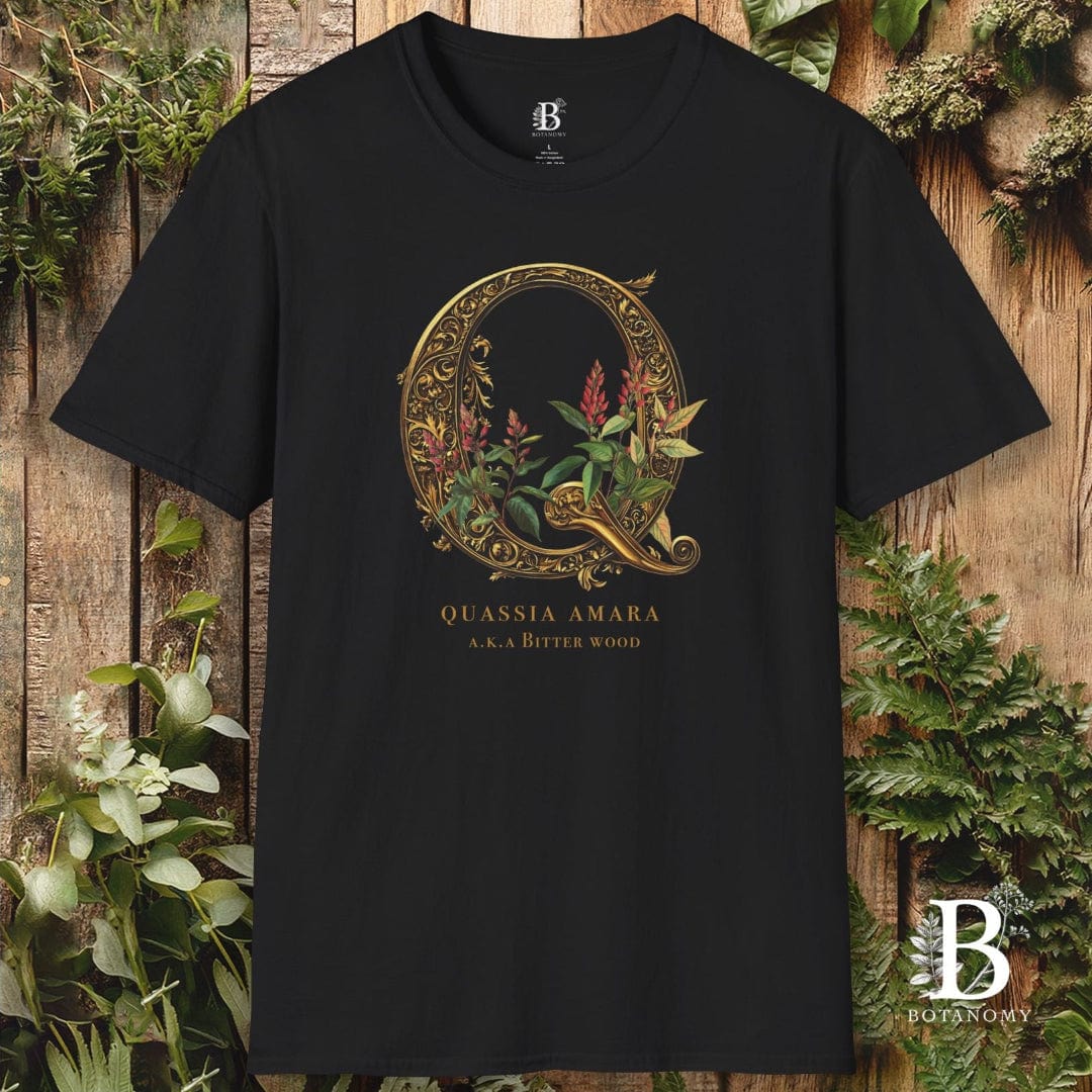 Black t-shirt with decorative 'Q' design and text on a wooden background with plants