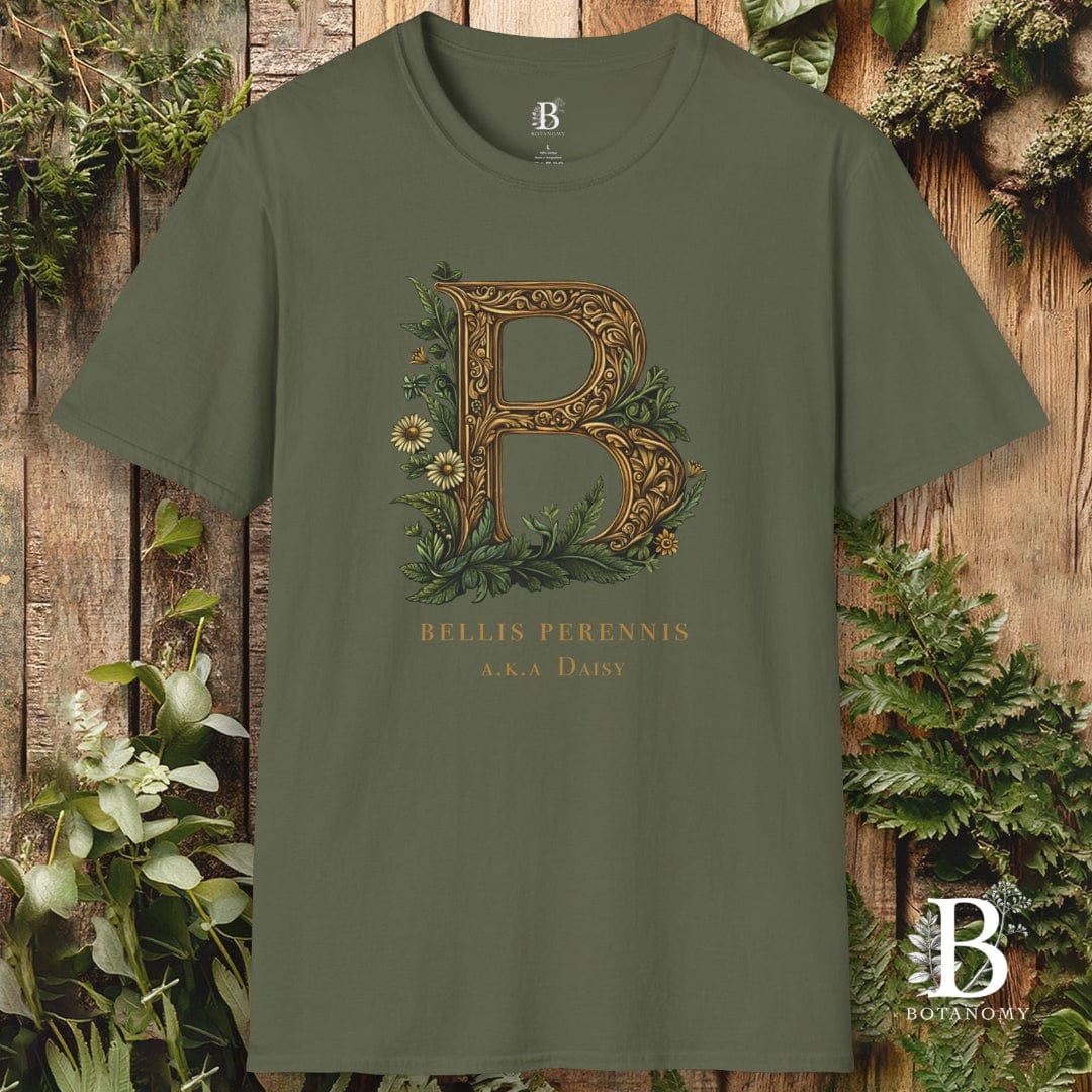 Green t-shirt with decorative letter 'B' design on a wooden background with plants
