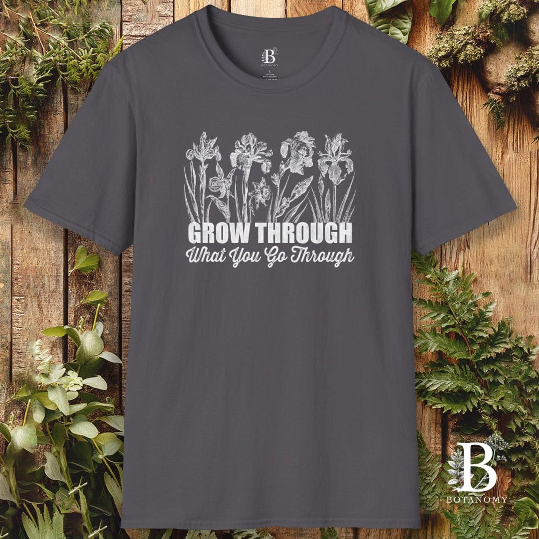 Gray t-shirt with floral design and motivational quote on a wooden background
