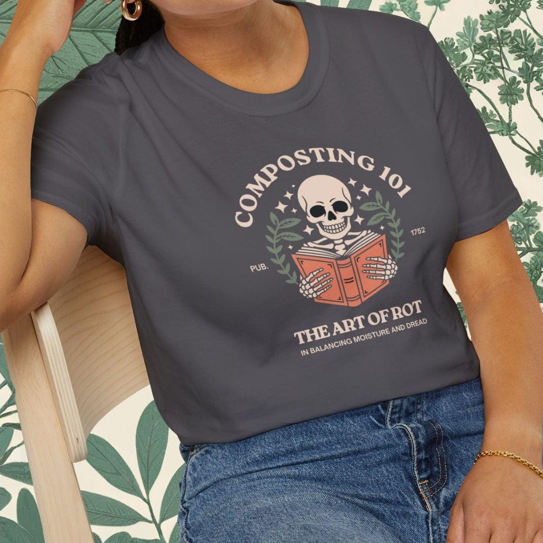 Person wearing a gray t-shirt with a graphic design sitting on a chair.