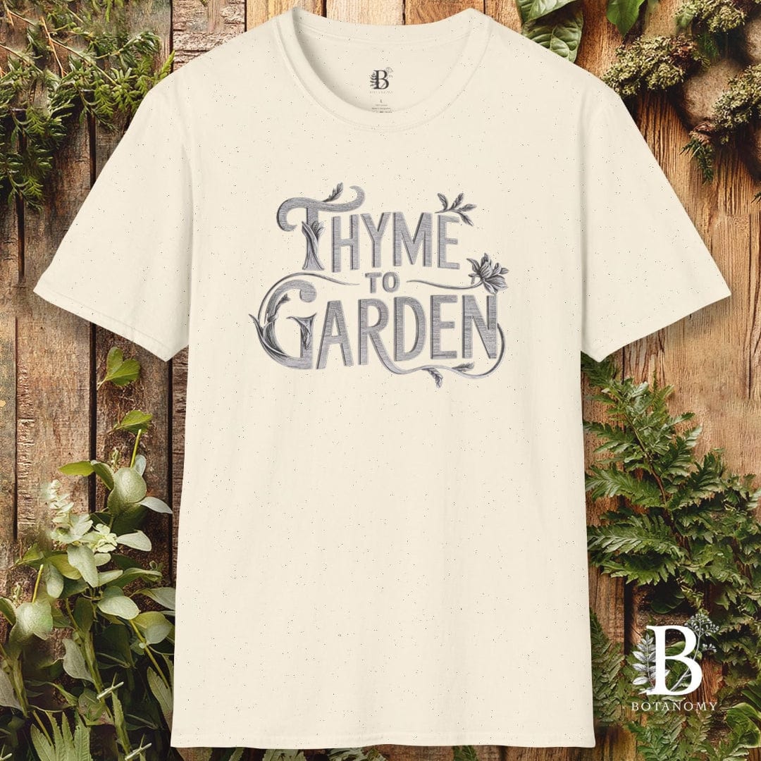 Beige t-shirt with 'Thyme to Garden' text on a wooden background with plants