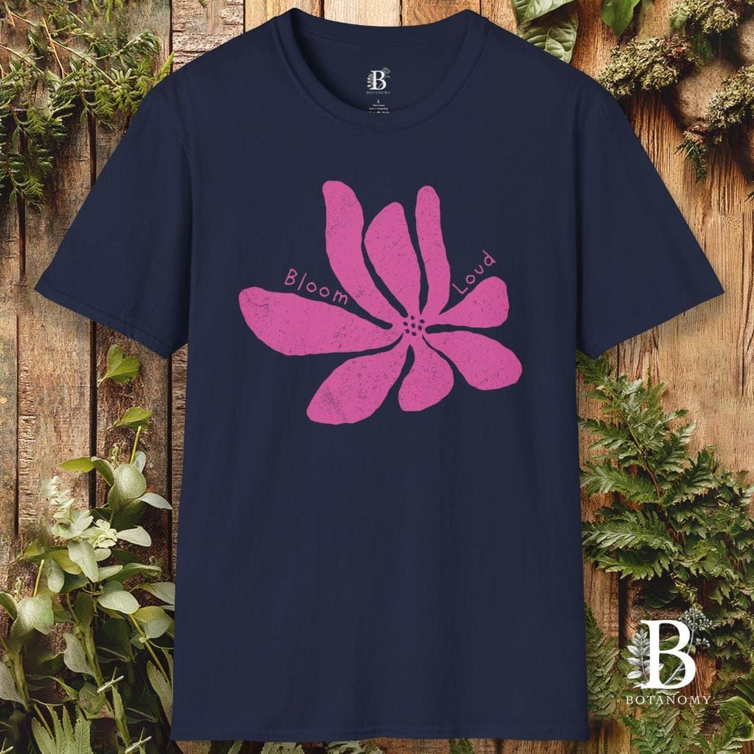 Navy blue t-shirt with pink floral design and brand logo on a wooden background