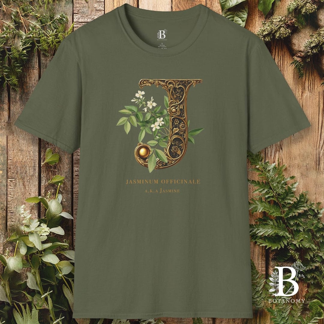 Green t-shirt with decorative letter 'J' design on a wooden background with plants