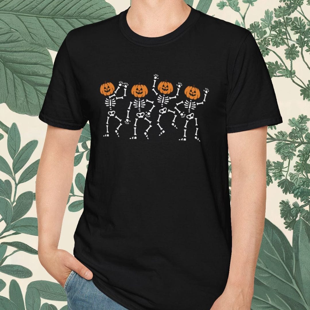 Person wearing a black t-shirt with skeleton and pumpkin design, standing against a leafy background.