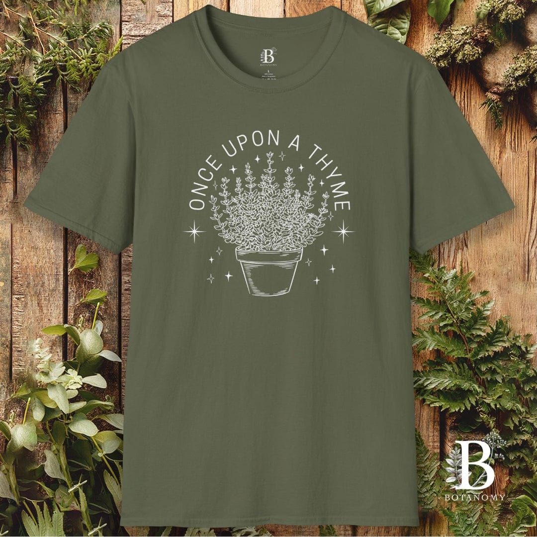Green t-shirt with a floral design and text on a wooden background