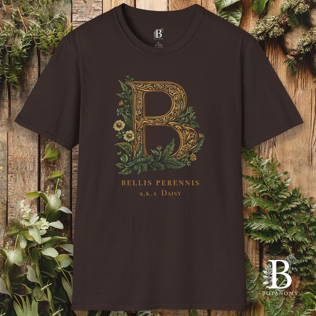 Brown t-shirt with decorative letter 'B' and floral design on a wooden background