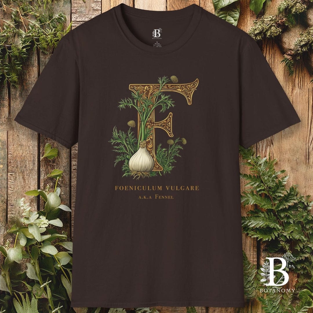 Brown t-shirt with decorative letter 'F' design featuring an onion, against a wooden background with plants.