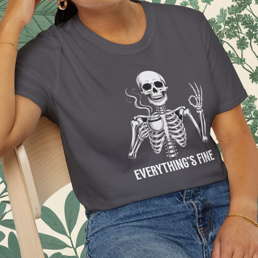 Person wearing a dark gray t-shirt with a skeleton graphic and 'EVERYTHING'S FINE' text, sitting on a chair.