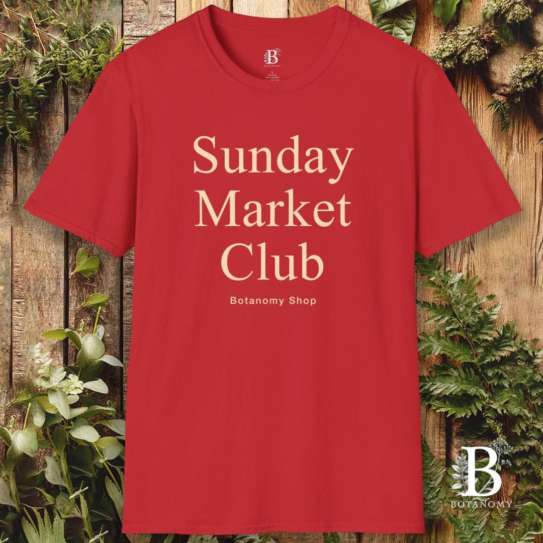 Red t-shirt with 'Sunday Market Club' text on a wooden background