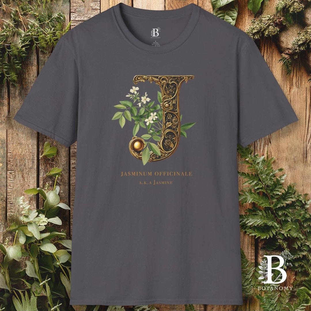 Gray t-shirt with decorative letter 'J' design on a wooden background with plants