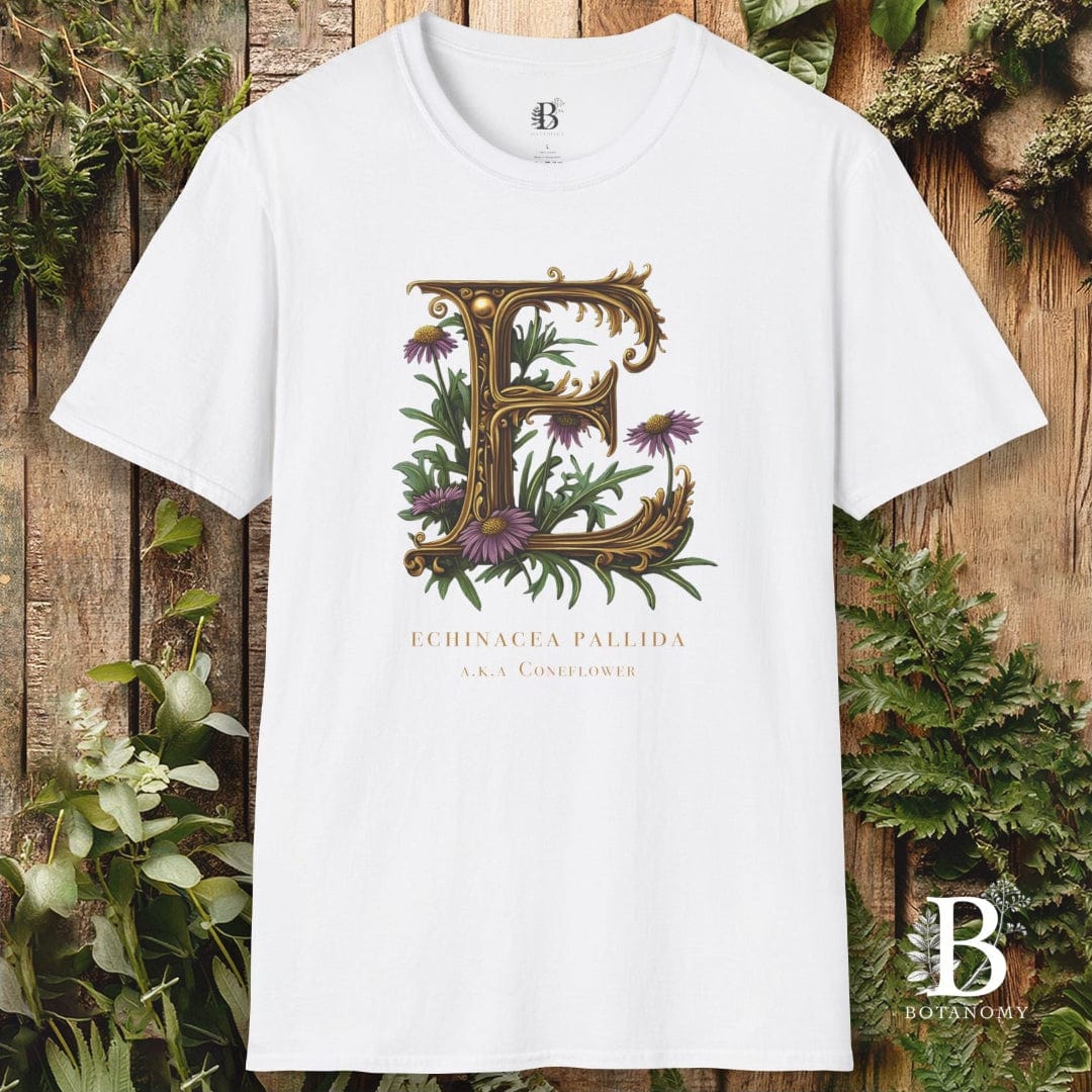 White t-shirt with floral letter 'E' design on a wooden background