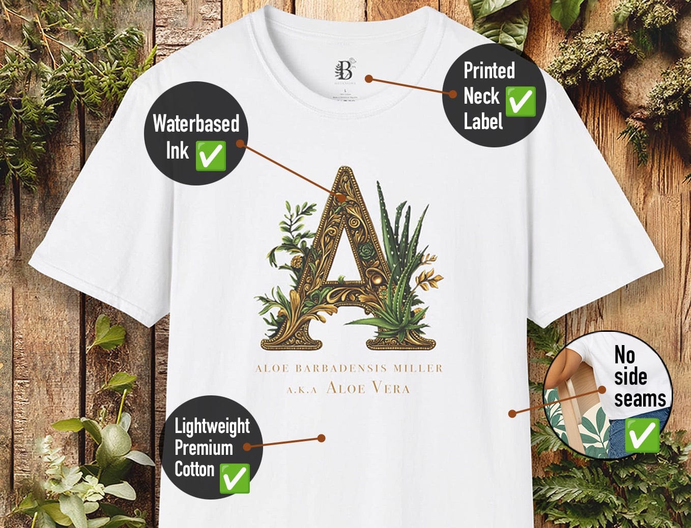 White t-shirt with a decorative letter 'A' design on a wooden background with plants.