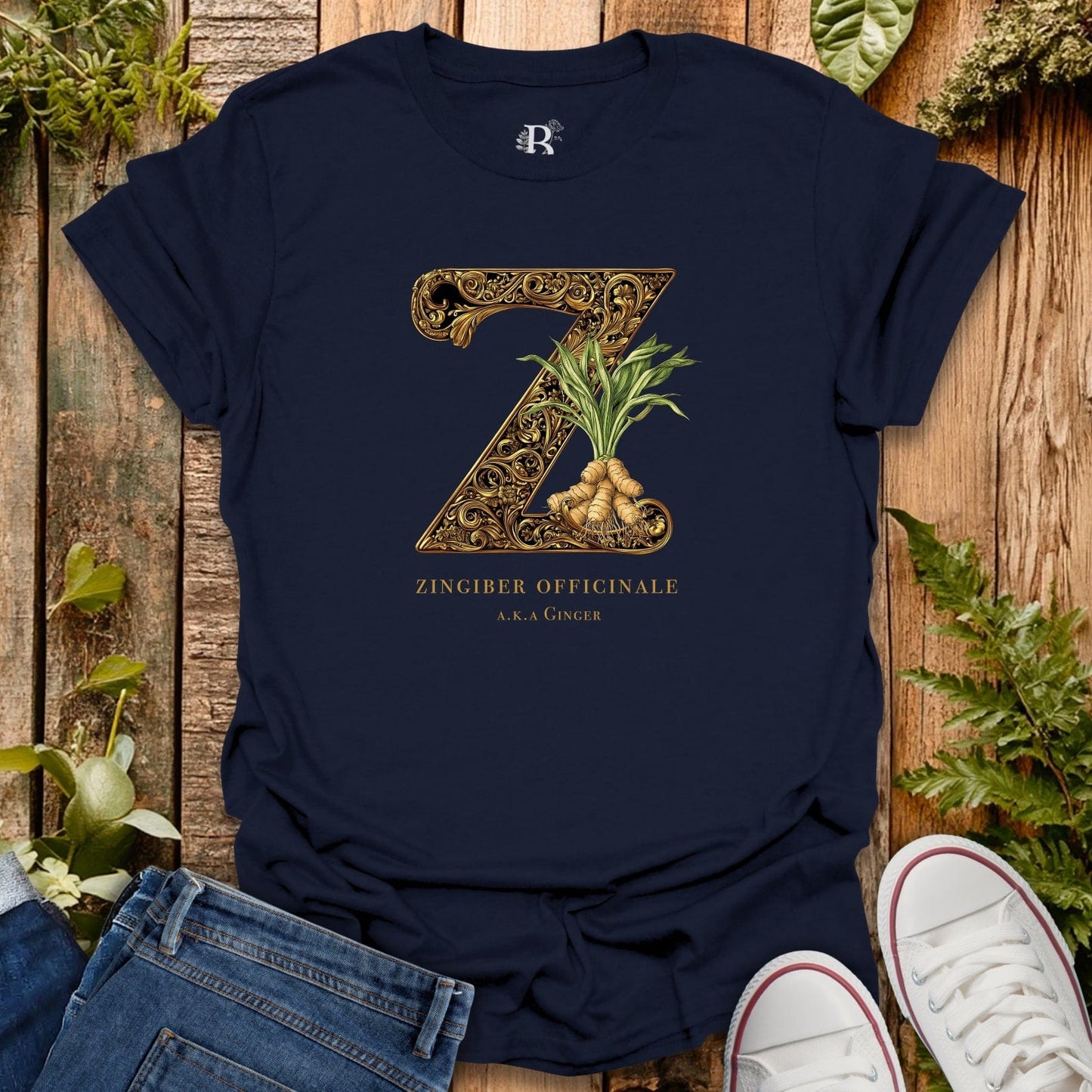 Navy blue t-shirt with gold 'Z' design and ginger plant on a wooden surface with plants.