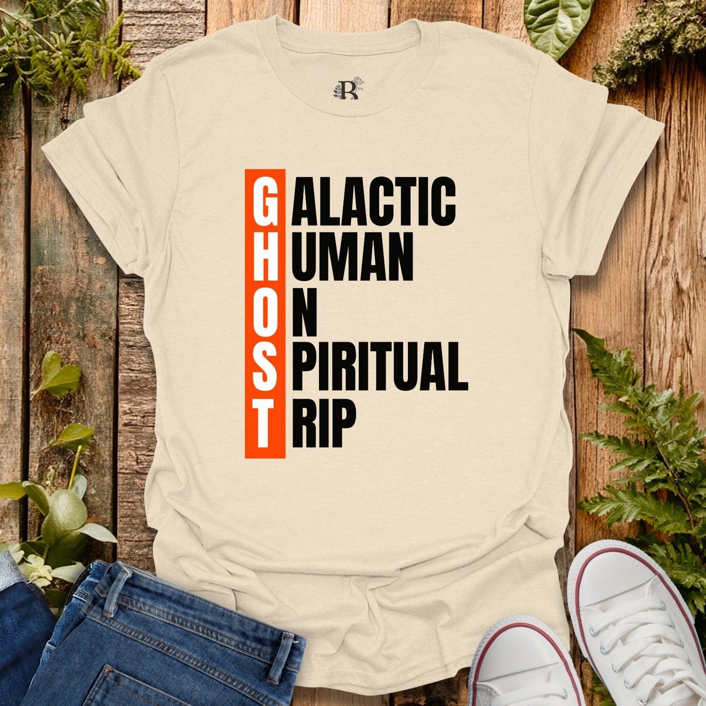 Beige t-shirt with text design on a wooden surface with plants