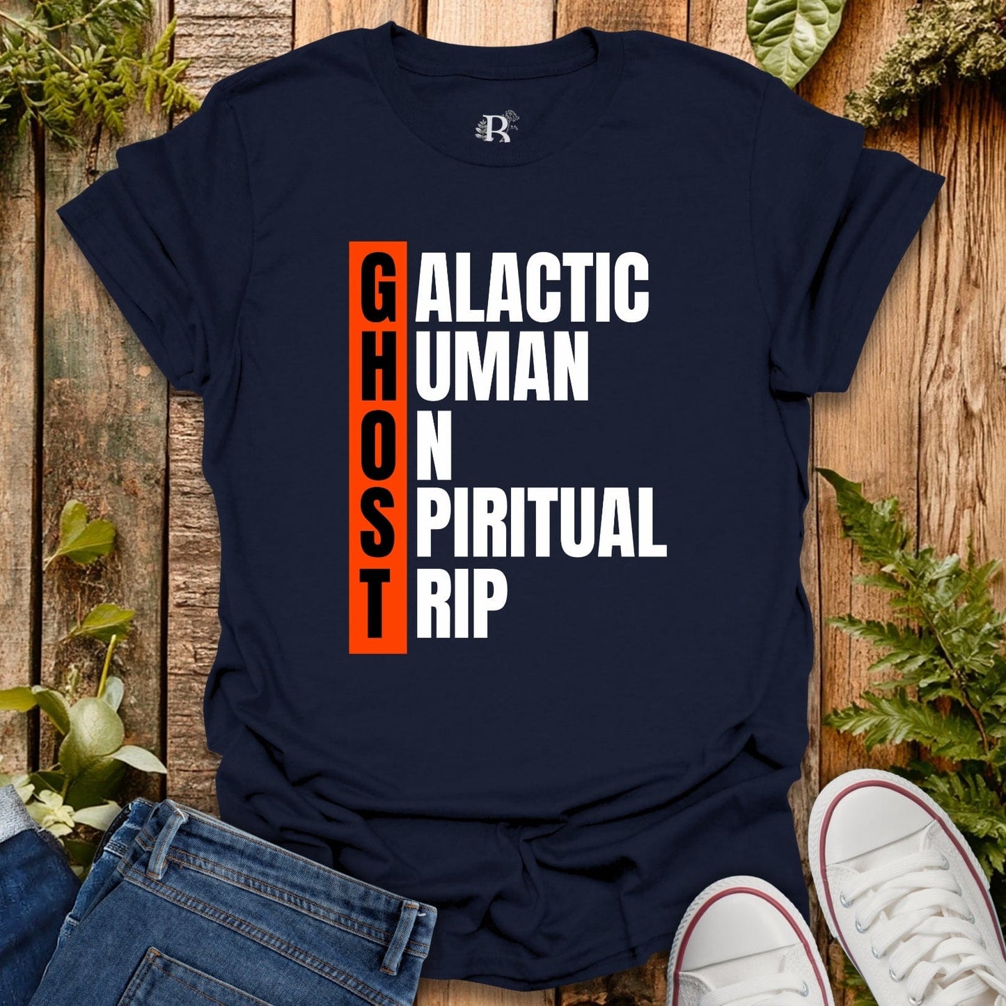 Navy blue t-shirt with text design on a wooden surface with plants.