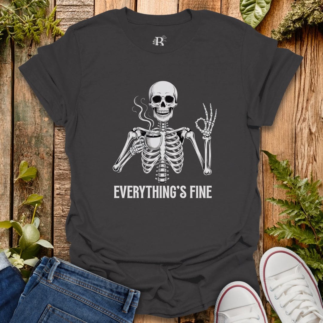 Black t-shirt with skeleton graphic and 'Everything's Fine' text on a wooden surface with jeans and sneakers.