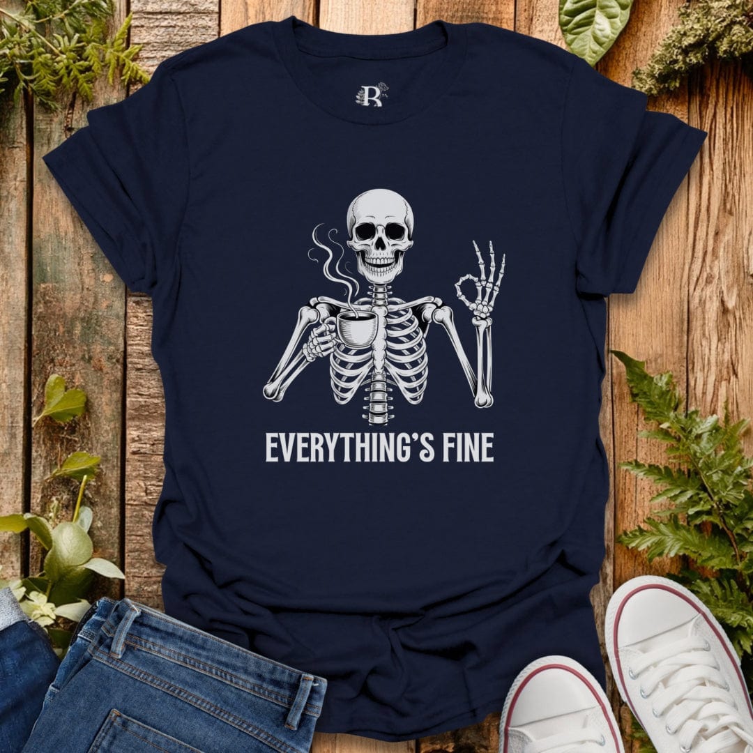 Navy blue t-shirt with a skeleton graphic and 'EVERYTHING'S FINE' text on a wooden surface with plants.