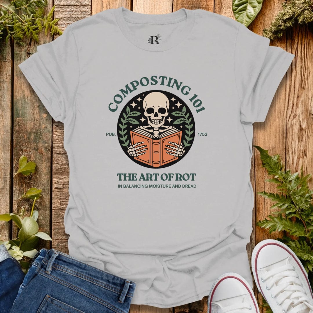Gray t-shirt with composting graphic design on a wooden background with plants.