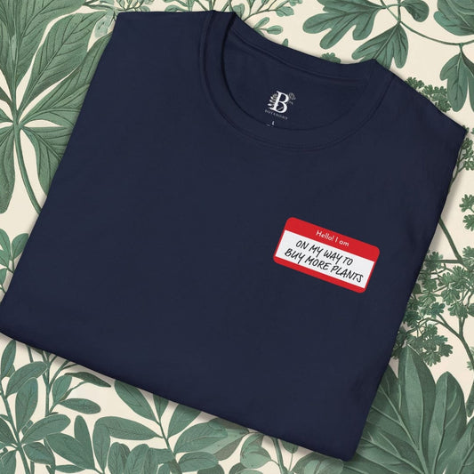 Navy blue sweatshirt with a red name tag label on a floral background